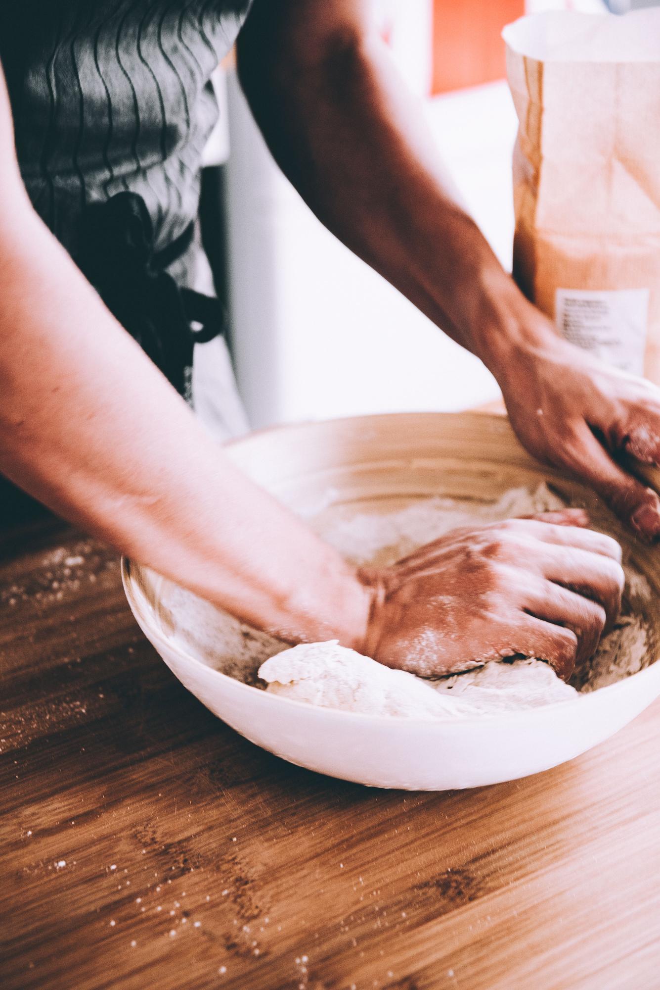 Student preparing dough at workbench
